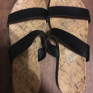 Black slip on sandals.